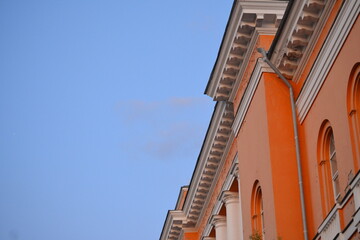a very nice facade with red paint and a decorative rain gutter