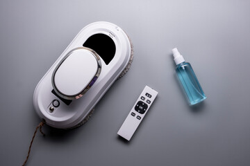 Vacuum cleaner robot washing glass window. Robot assistant at home for cleaning windows or mirrors.