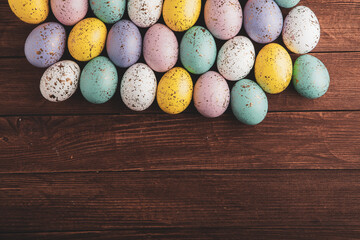 Hand painted pastel colored Easter eggs background. Happy Easter greeting card or invitation.