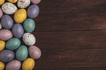 Hand painted pastel colored Easter eggs background. Happy Easter greeting card or invitation.