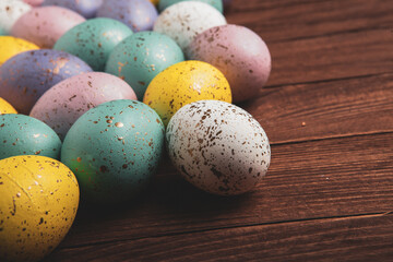 Hand painted pastel colored Easter eggs background. Happy Easter greeting card or invitation.