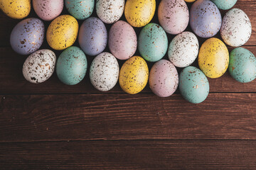 Hand painted pastel colored Easter eggs background. Happy Easter greeting card or invitation.