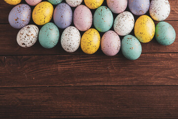 Hand painted pastel colored Easter eggs background. Happy Easter greeting card or invitation.