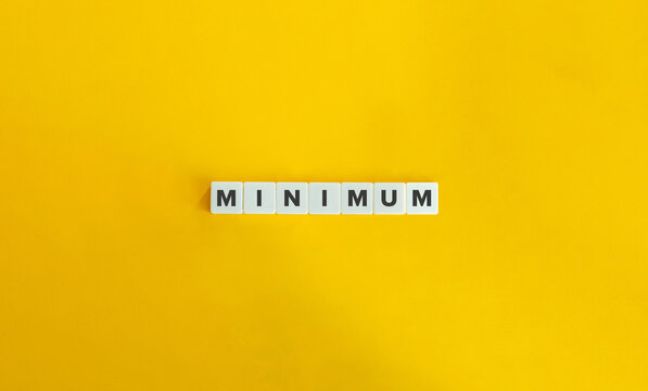 Minimum Word on Letter tiles on bright orange background. Minimal aesthetics.