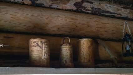 Vintage birch bark products. Birch bark containers for storing food on the kitchen shelf in an old wooden house.