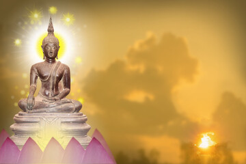 Buddha statue sitting on a pink lotus flower.