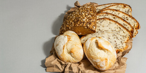 Freshly baked bread, buns, and toasts. Parchment, trendy hard li