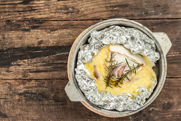 Melted Rougette cheese with fresh rosemary and garlic. Soft-ripened red rind cheese
