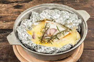 Melted Rougette cheese with fresh rosemary and garlic. Soft-ripened red rind cheese