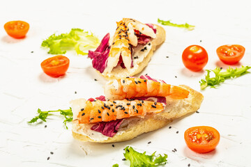 Open sandwiches with boiled shrimps, cream cheese, salad leaves, and cherry tomatoes