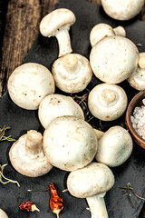 Fresh champignons with spices and herbs. Raw ingredient for cooking vegan food