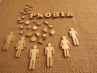 mental illness-phobia in the form of wooden letters and figures of people on a jute background. High quality photo