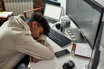 Exhausted african american male trader fall asleep off at workplace
