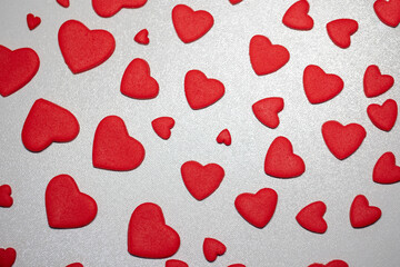 Festive composition from sugar red hearts scattered and isolated on white background. Valentine, love, wedding, marriage concept, abstract background.