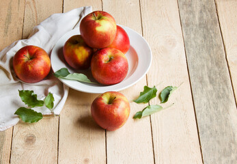 Ripe apples on wooden background. Free space for text.