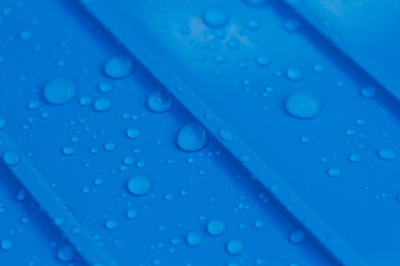 Water droplets scattered on blue background.