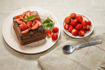 Homemade baking. Chocolate cake with strawberries and mint.