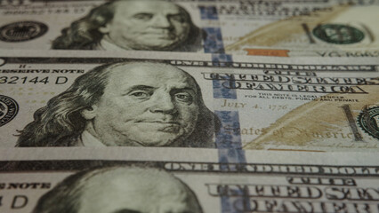 One hundred dollar bills sliding from bottom to top, economy and finance concept