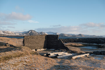 Ruined stables in a lava field near Grindavik at the Hopsnesviti lighthouse on the coast of the...