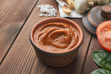 homemade umami paste with tomatoes parmesan cheese shitake mushrooms soy sauce garlic sea salt walnuts chicken broth miso paste in a bowl on brown background