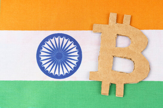 The flag of India has a bitcoin symbol cut out of cardboard.
