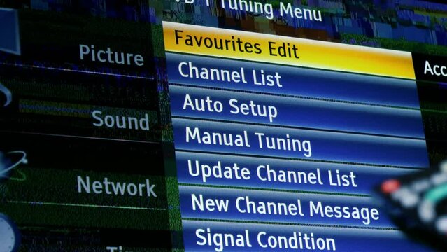 POV man hand holding remote control in front of generic tv menu while trying to resolve the bad signal reception in picture sound network menu - dbv-t transmisison menu