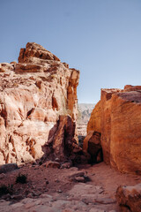 Ruins of the ancient city of Petra in Jordan. Red sandstone mountains on a clear day. Caves in the rock. Landscape. Colorful photos.