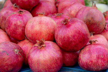 Selective focus of fresh ripe fruit display on the market stall, The pomegranate (Punica granatum) is a fruit-bearing deciduous shrub in the family Lythraceae subfamily Panicoideae. 