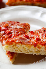 Real homemade italian pizza with tomatoes, ham and cheese.
