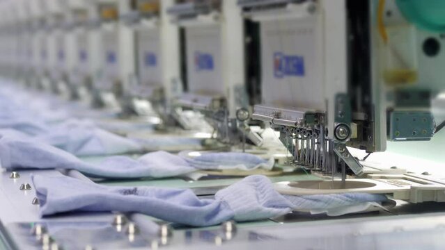 Automatic sock stitching at garment factory, machine embroidery line, manufacture of clothing