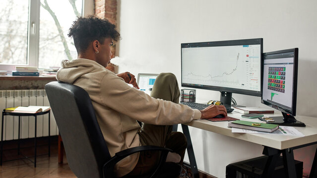 Worried stressed african american trader vaping and watching data index chart stock market - Powered by Adobe