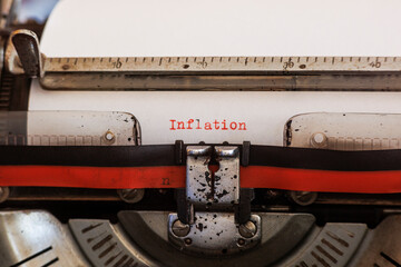 The German word inflation written with an old mechanical typewriter with red and black ribbon in...