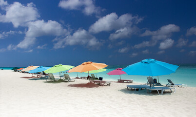 Colorful parasol and chairs on a tropical sandy beach. Aruba, ABC