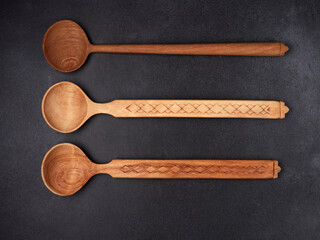 handmade wooden spoons on a dark background