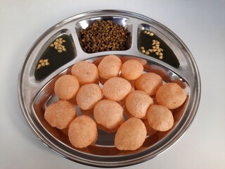 Indian pani puri with spicy water and boiled moong