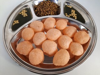 Indian pani puri with spicy water and boiled moong
