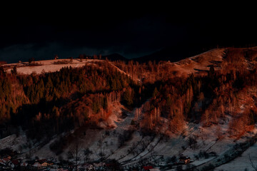 Idylic sunset light over Bucegi Mountains, Romania. Fundata village landscape