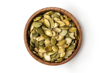 Pumpkin seeds on wooden bowl isolated on white background.