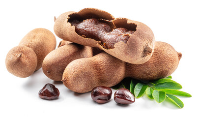 Ripe tamarind fruit, leaves and some tamarind seeds isolated on white background.