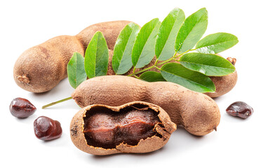 Ripe tamarind fruit, leaves and some tamarind seeds isolated on white background.