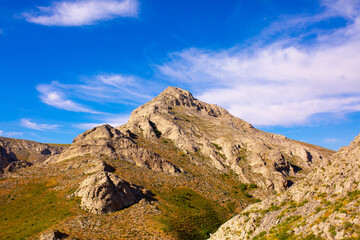 Beautiful nature of rocky mountains. Unusual landscape of nature. Trees among the rocks against the sky with clouds.