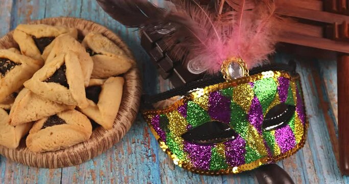 Hamans ears cookies noisemaker and mask for Purim celebration jewish holiday carnival