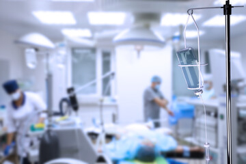 Drop counter with bottle of medicine in operating room. Space for text