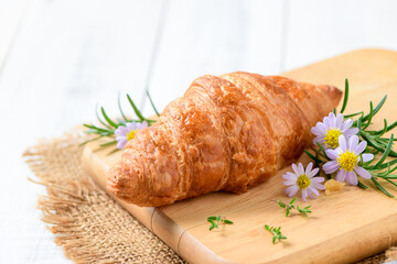 Butter Croissant on wood plate and white wood background,