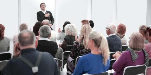 Audience of adult people listen to the speech of the lecturer