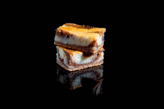 Besquit, cake on a black background, dark and light layer of besquit on a black background, reflection, copy space