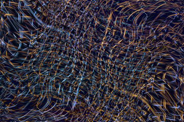 Wave of light beams on stage with blue scheme from a music festival. Rays of searchlights looks very strong against the darkness as a background.