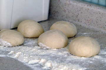 dough pieces, a person who rolls dough to make donuts,
