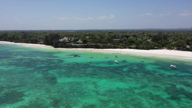 Drone Coastline Diani beach landscape Kenyan African Sea  aerial 4k waves blue indan ocean tropical mombasa turquoise white sand East Africa palms paradise view Wood boats on water kite surfing