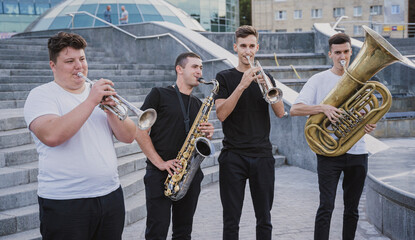Young street music band play a lot of musical instruments